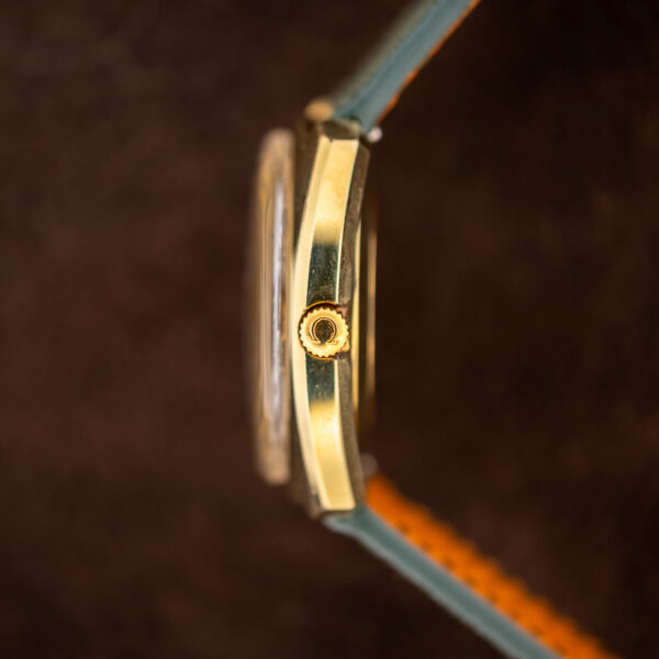 Crown-side profile of the Omega 166.053 showing the Omega-symbol crown and raised crystal