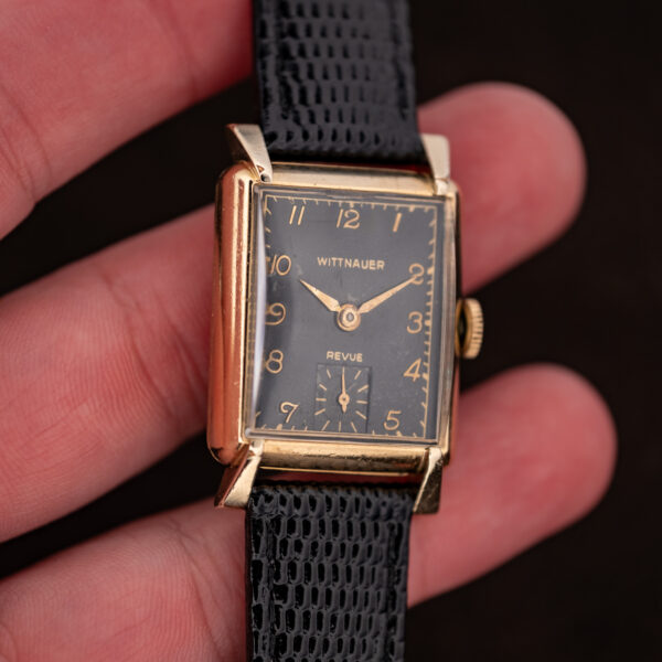Wittnauer Revue held in hand, black Arabic dial and square small seconds in a 10k gold-filled case
