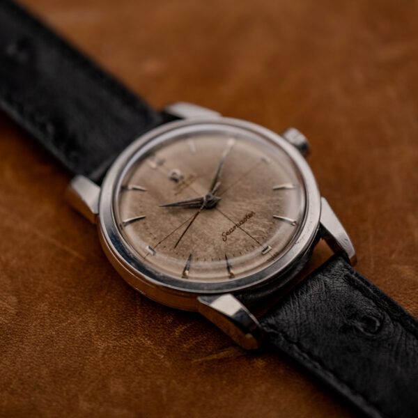 Low oblique view of the Omega 2846-1 SC with its mottled dial under a domed crystal