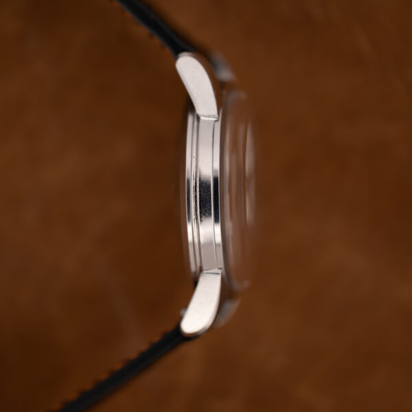 Opposite profile of the Omega Seamaster case showing the domed crystal and polished case flank