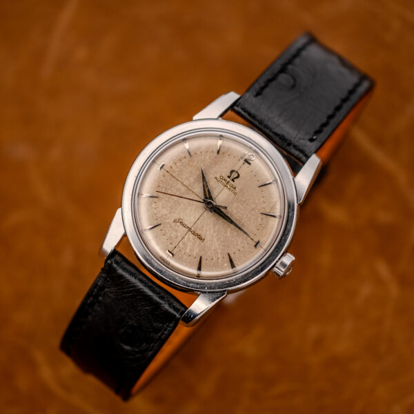 Raised front view of the vintage Omega Seamaster crosshair dial with the black ostrich strap looped behind