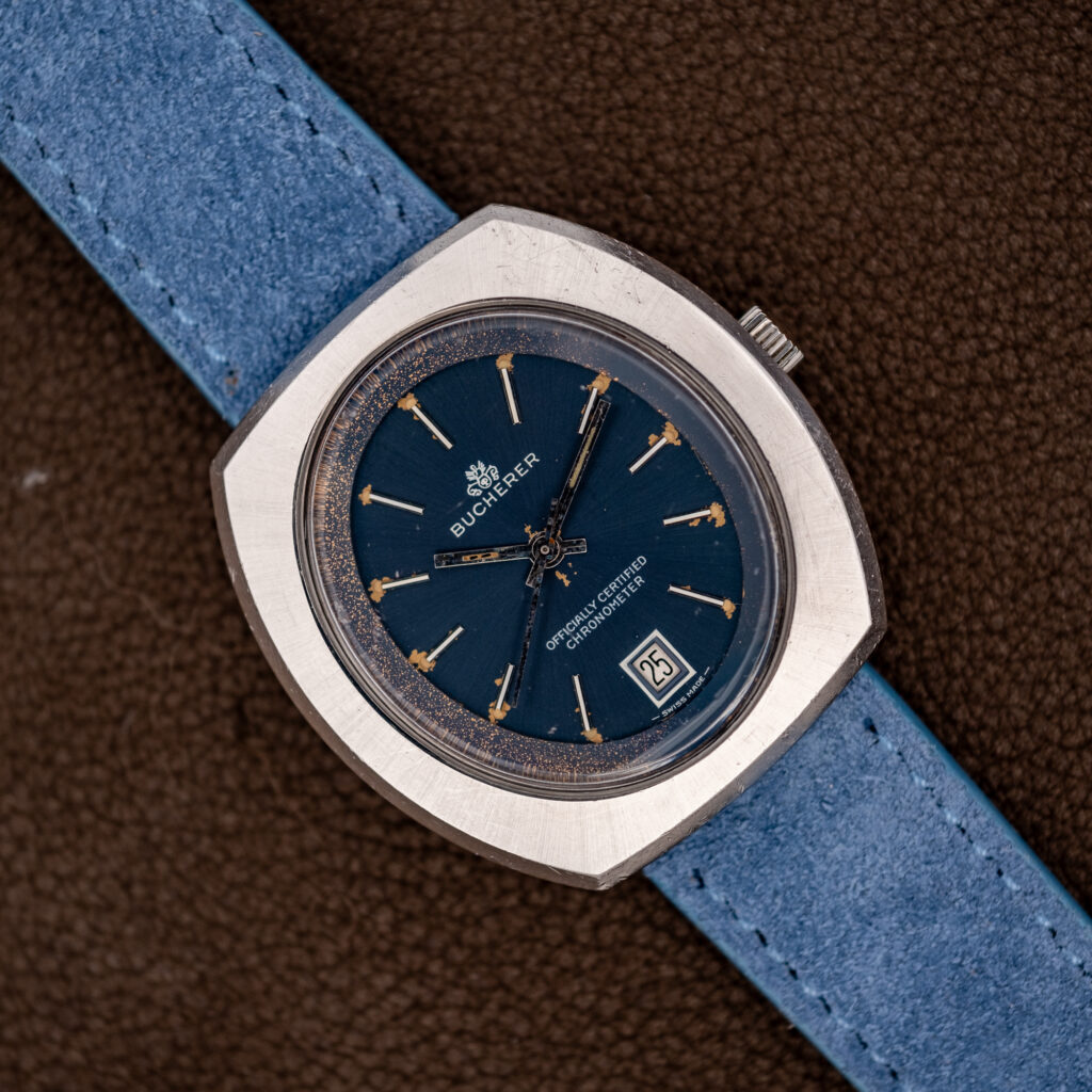 Bucherer 1574 chronometer at an angle, blue dial with date at six on a powder-blue suede strap