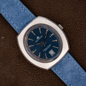 Bucherer 1574 chronometer at an angle, blue dial with date at six on a powder-blue suede strap