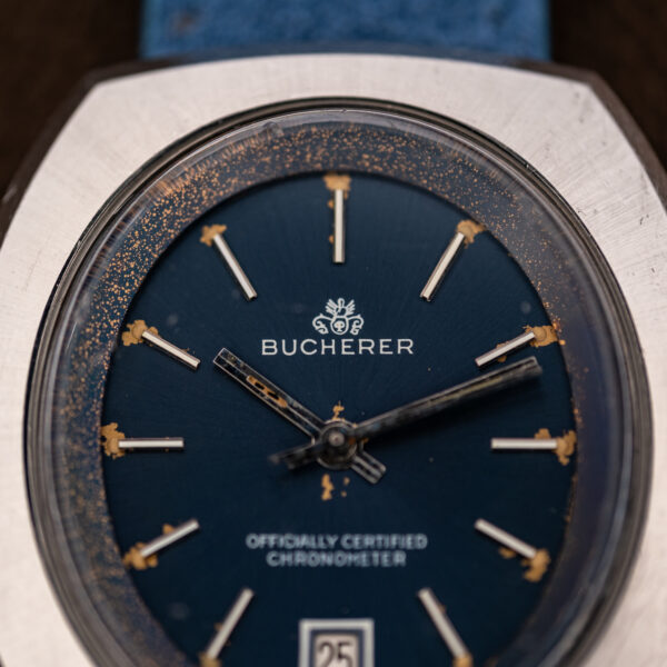 Upper dial close-up of the Bucherer 1574 showing the crest, BUCHERER signature and applied batons