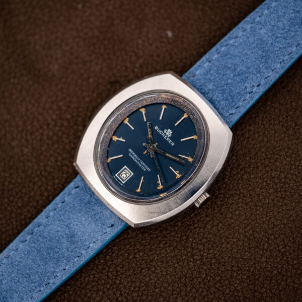 Angled view of the Bucherer 1574 showing the blue dial in its oval opening within the broad case