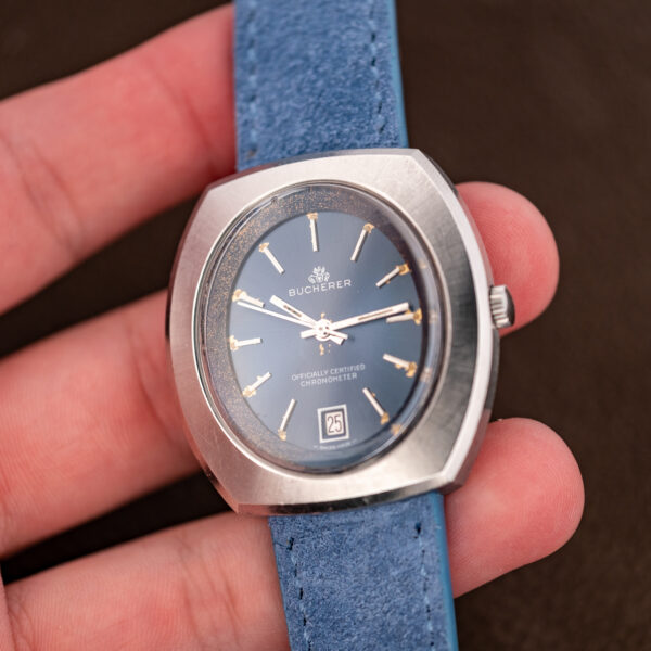Bucherer 1574 held in hand, showing the blue dial in its oval window and powder-blue strap
