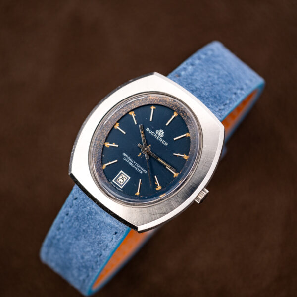 Bucherer 1574 on a watch stand, blue Officially Certified Chronometer dial facing forward