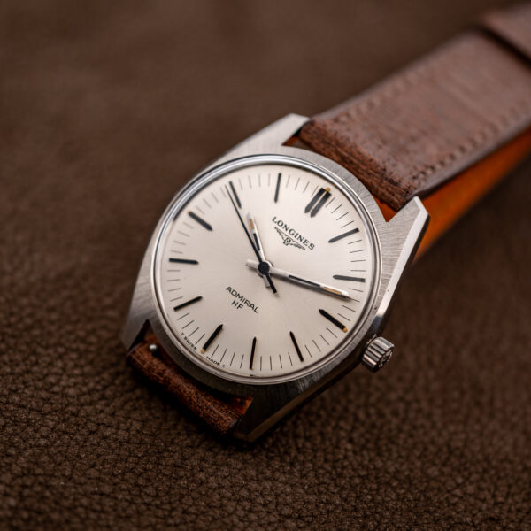 Three-quarter view of the Longines Admiral HF 2301-4 with black-inset hour markers and yellow-toned hand inserts