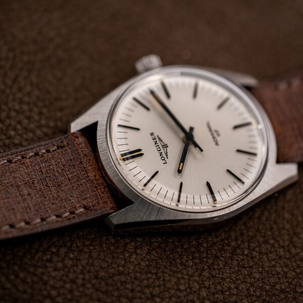 Low oblique angle on the Longines Admiral HF dial, its no-date layout and pointed batons catching the light
