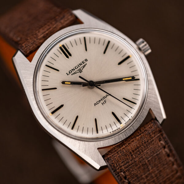 Oblique close-up of the Longines Admiral HF face with central seconds, baton hands and radial dial finish
