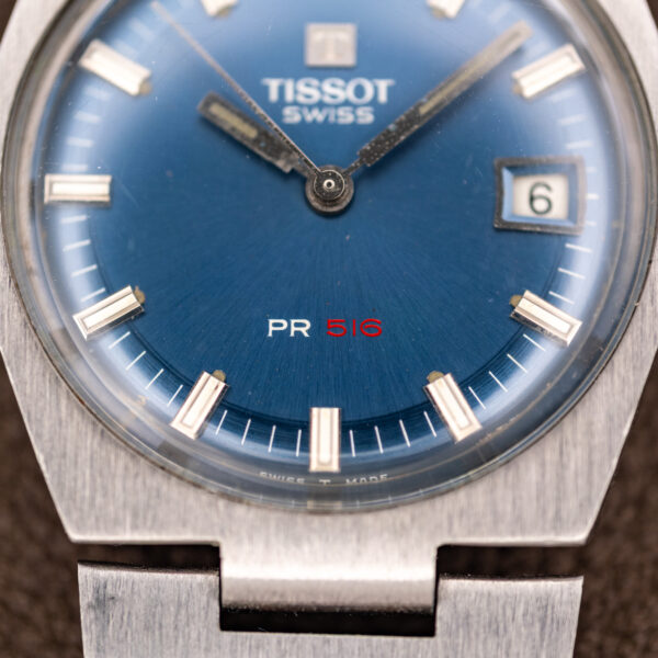Close-up of the lower Tissot dial with white PR and red 516 lettering and SWISS T MADE edge text