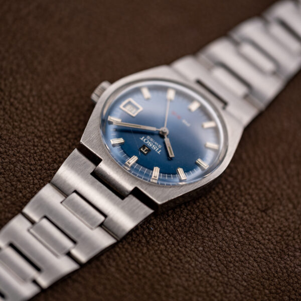 Tissot PR 516 low side view showing the raised crystal and the narrow center bracelet attachment