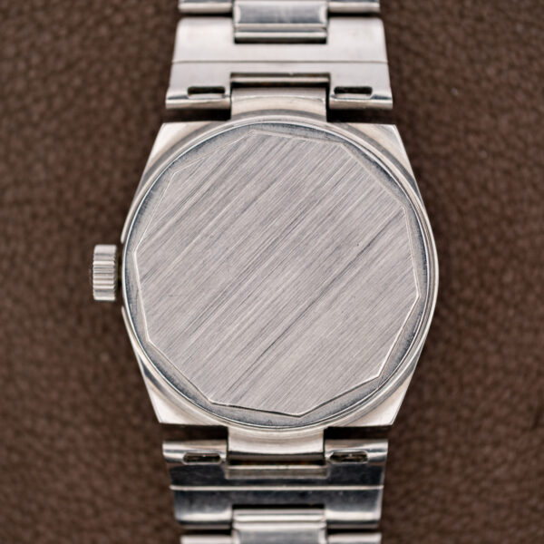 Back of the Tissot 42630-4X showing the brushed unlettered caseback between the steel bracelet attachments