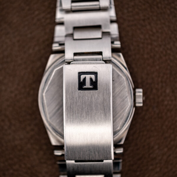 Closed Tissot folding clasp on the steel bracelet, seen from the outside of its cover