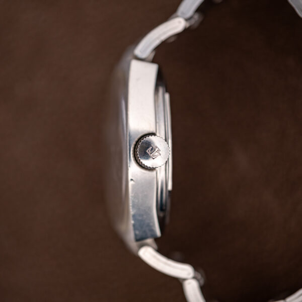 Crown side of the Tissot PR 516 with the winding crown and the bracelet end links