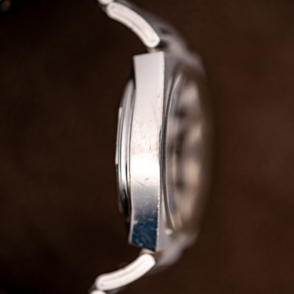 Tissot PR 516 opposite profile with caseback seam, crystal edge and wide steel bracelet links