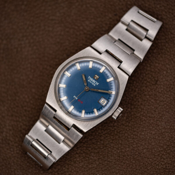 Tissot PR 516 on a display stand, showing the full steel cushion case and bracelet