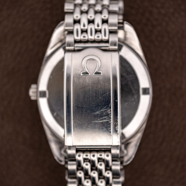 Underside of the Omega Seamaster bracelet showing the folding clasp with the Omega symbol on its cover