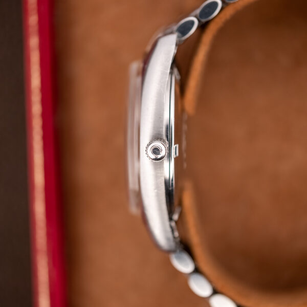 Crown-side profile of the Omega Seamaster 166.067 with the Omega-signed crown and curved one-piece case