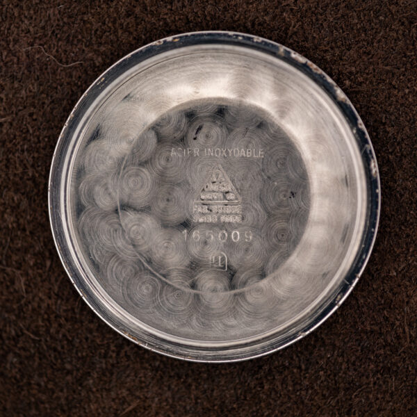 Inside caseback of the Omega Seamaster with ACIER INOXYDABLE, Omega marks and the 165009 stamp
