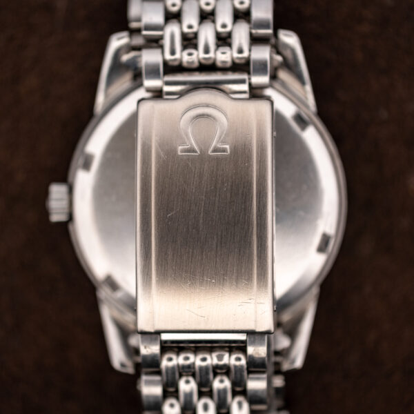 Closed Omega folding clasp of the Seamaster bracelet showing the Omega symbol on brushed steel