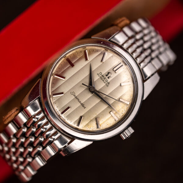 Opposite case profile of the steel Omega Seamaster showing the domed crystal, lugs and bracelet