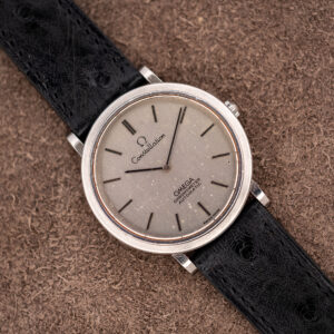 Omega Constellation 157.0001 seen diagonally, showing the flecked silver dial, baton markers and black ostrich strap