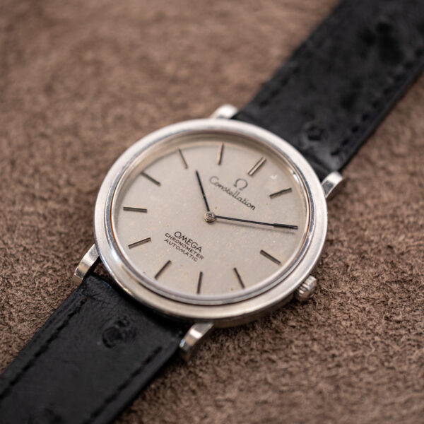 Low crown-side three-quarter view of the Omega Constellation 157.0001, showing the brushed silver dial and steel case