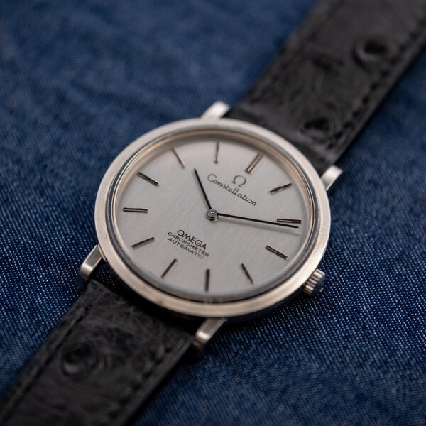 Low crown-side view of the Omega Constellation 157.0001 ultra-thin chronometer with silver dial and steel case