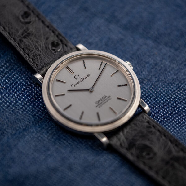 Low angle from the left of the Omega Constellation automatic chronometer, silver dial and baton markers