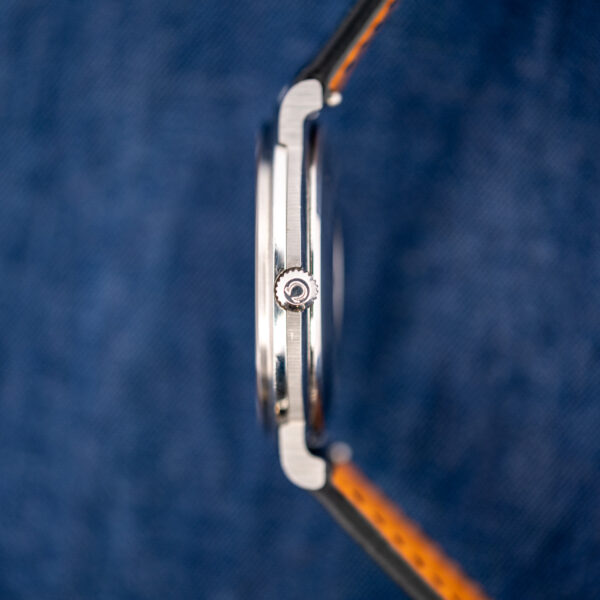 Crown-side profile of the slim Omega Constellation 157.0001 case with the Omega-signed crown