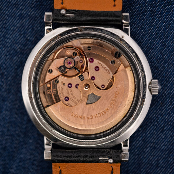 Open caseback of the Omega Constellation 157.0001 showing the caliber 712 movement, rotor and serial number