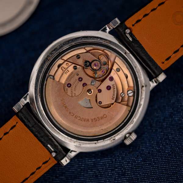 Omega caliber 712 automatic movement at an angle, with caliber stamp, adjustment text and signed rotor