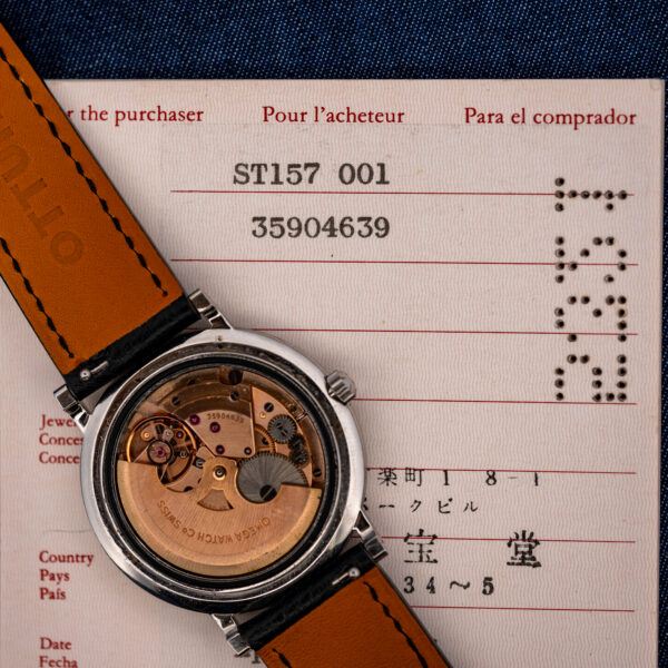 Omega 712 movement resting on its guarantee, both carrying movement number 35904639
