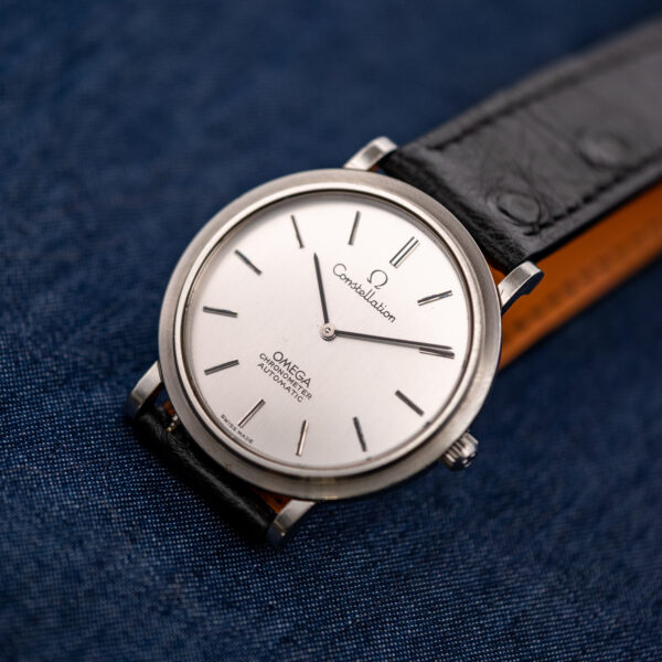 Three-quarter front view of the Omega Constellation 157.0001 with silver brushed dial and black strap