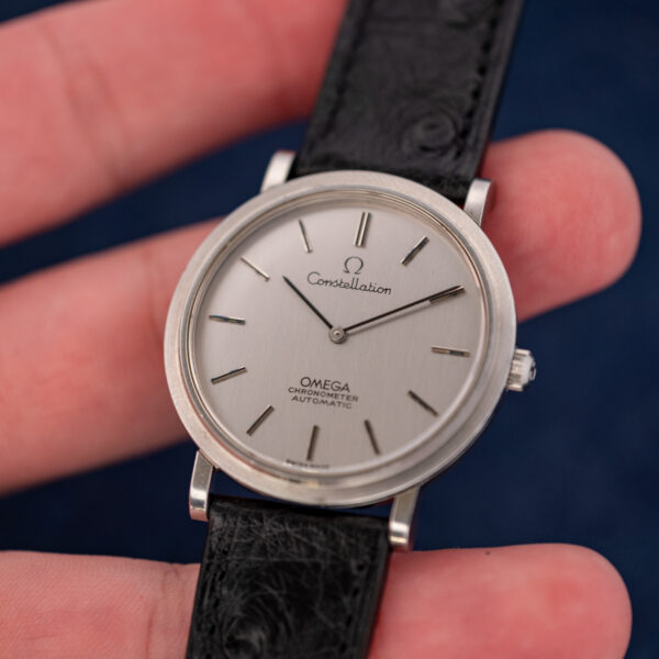 Omega Constellation 157.0001 held in hand, two-hand silver dial and black ostrich strap