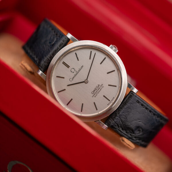 Hand-held angled view of the Omega Constellation automatic chronometer and its brushed silver dial