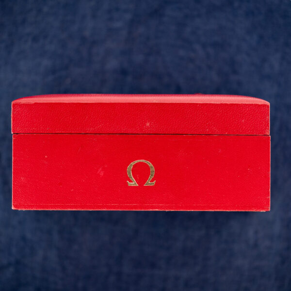 Omega Constellation 157.0001 sitting in a red Omega box, silver dial and black strap visible