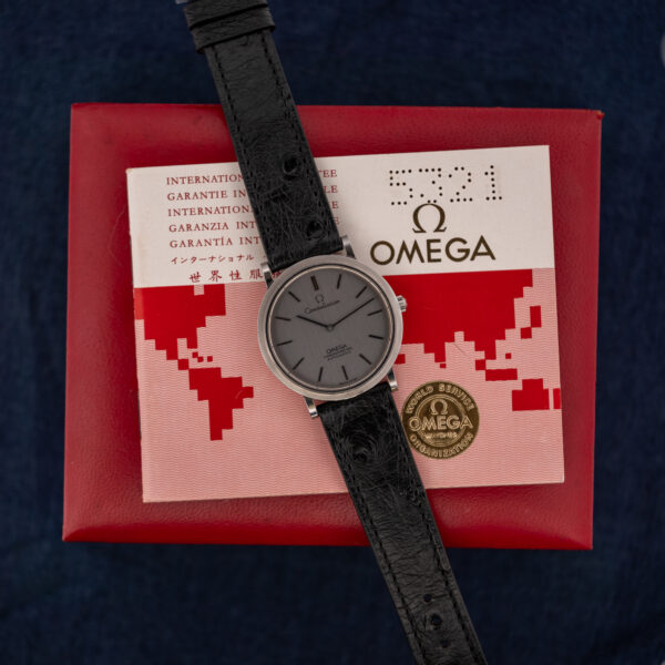 Omega Constellation 157.0001 set out with its guarantee booklet on top of a red Omega box