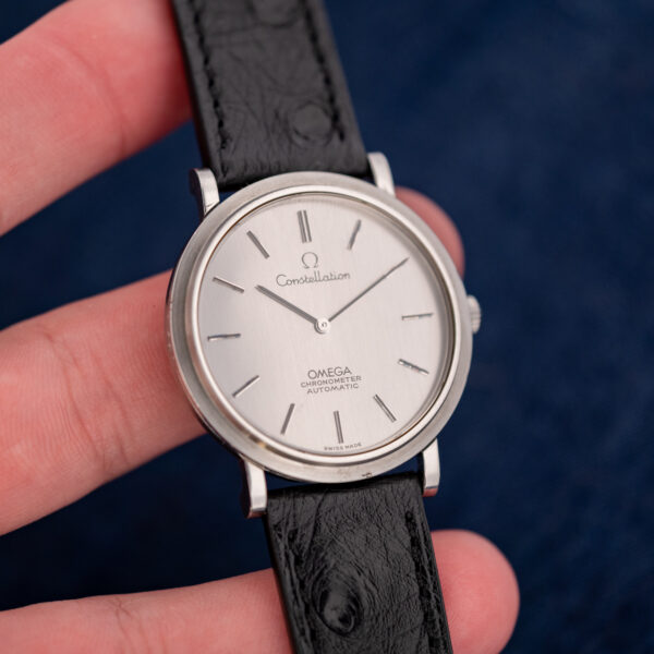 Omega Constellation 157.0001 under diffuse light in hand, showing the even finish of the silver dial