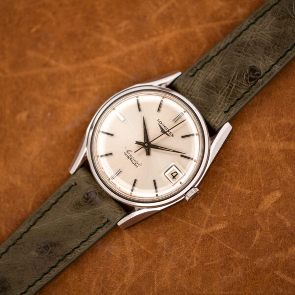 Wide diagonal view of the vintage Longines Conquest 7171-2 on its olive ostrich strap