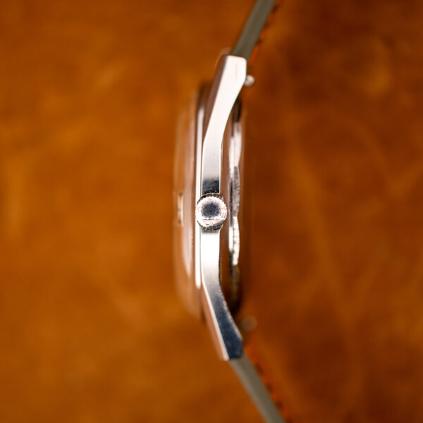 Crown side of the Longines Conquest 7171-2 case, showing the signed crown and raised crystal in profile