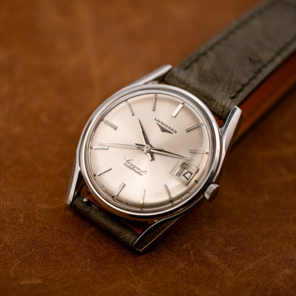 Low three-quarter view of the Longines Conquest 7171-2 with its silver dial, batons and hour plots
