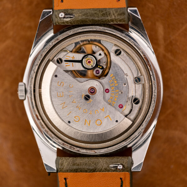 Open caseback of the Longines Conquest 7171-2 showing the signed automatic rotor and movement bridges