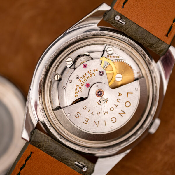 Signed rotor and engraved bridges of the Longines automatic movement inside the Conquest 7171-2, serial visible