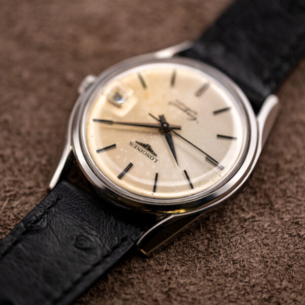 Low diagonal view of the vintage Longines Conquest 7171-5, its long lugs running into the black strap
