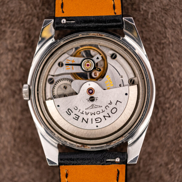 Open caseback of the Longines Conquest 7171-5 showing the automatic rotor signed in black-filled letters