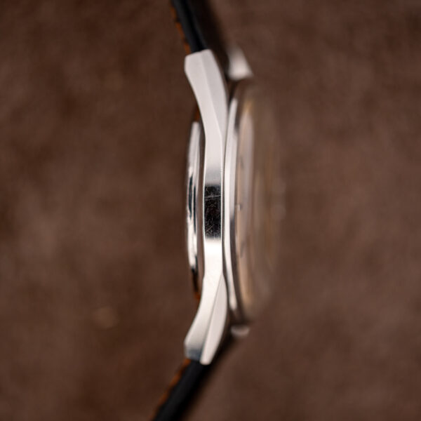 Left-side profile of the Longines Conquest 7171-5 showing the polished flank, curved lugs and back height