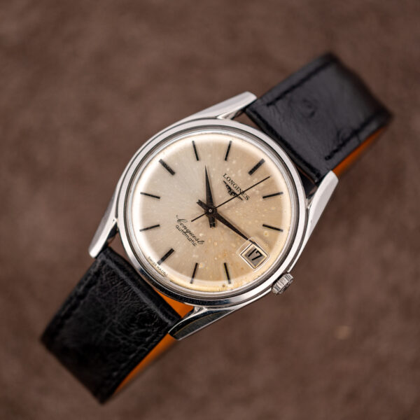 Raised three-quarter view of the Longines Conquest 7171-5 with the black ostrich strap fully in frame