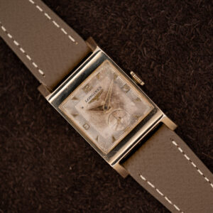 Longines Tank 2172-10 at an angle, showing the stepped-line rectangular dial, small seconds and taupe strap